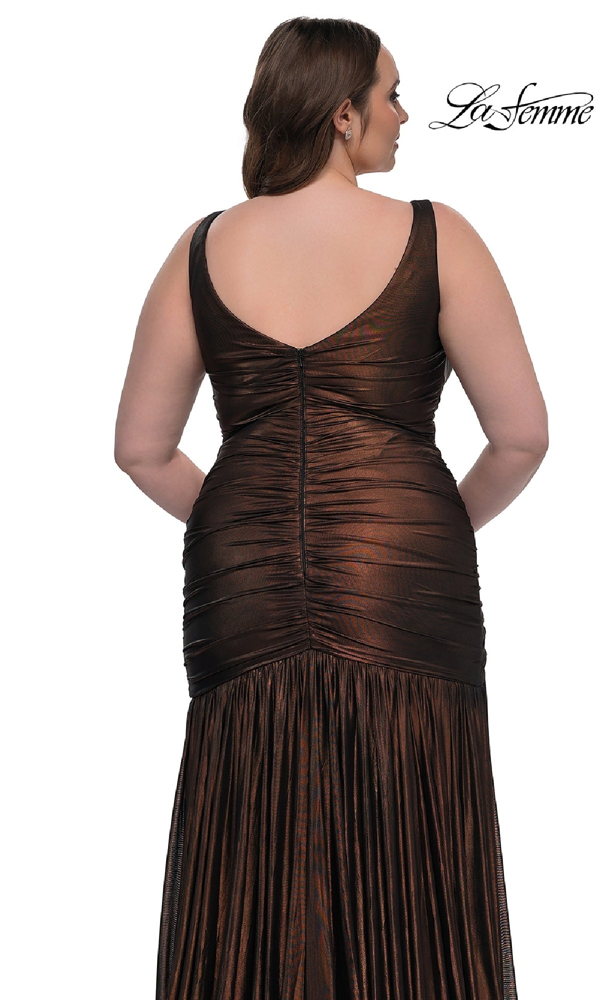 A woman models the La Femme 33021, a long plus-size sleeveless V-neck prom dress in metallic dark brown with a deep V-back and ruched details, shown from behind. The La Femme logo appears in the top right corner.